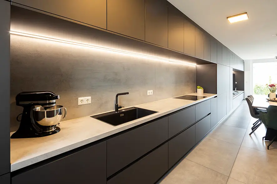 Modern black-and-white kitchen with sink, fridge and microwave